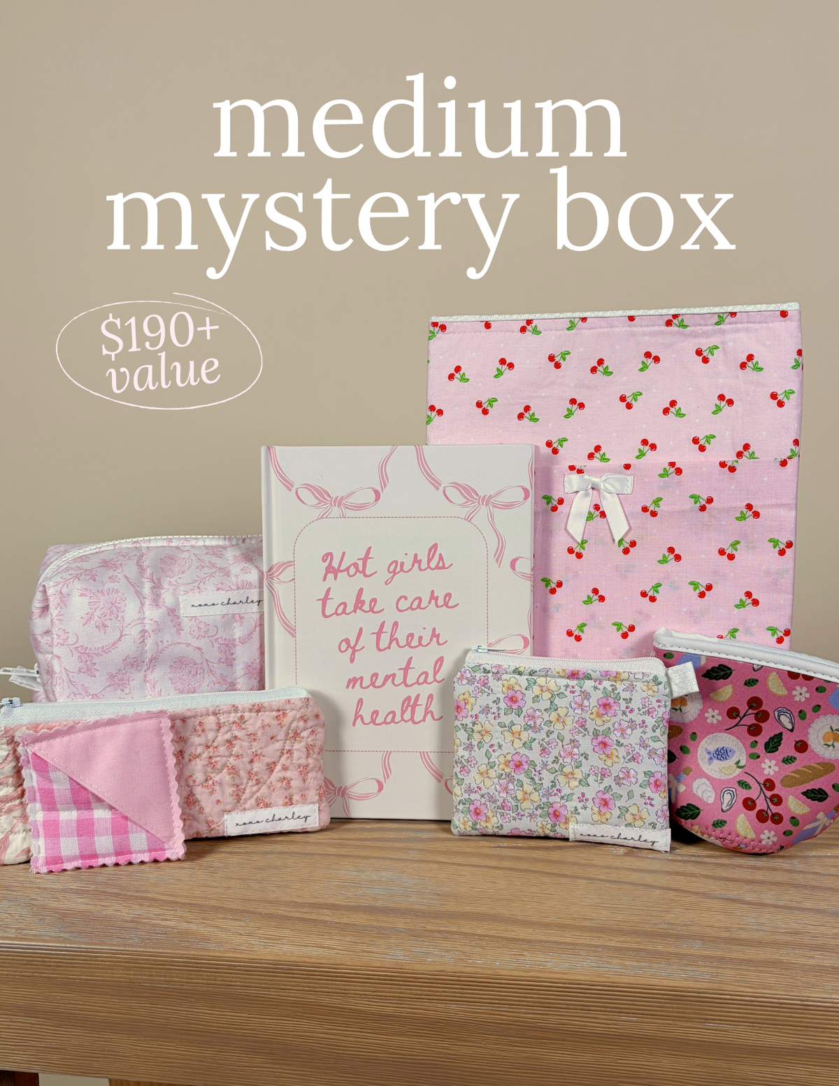 Medium mystery box with pink and multicolor printed bedding, fold blankets and pouches