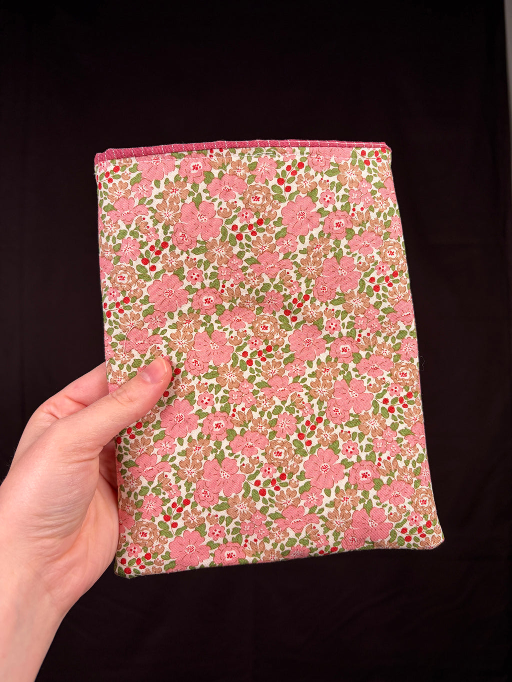 Floral e-reader sleeve with pink and green blossom print, rectangular fabric cover