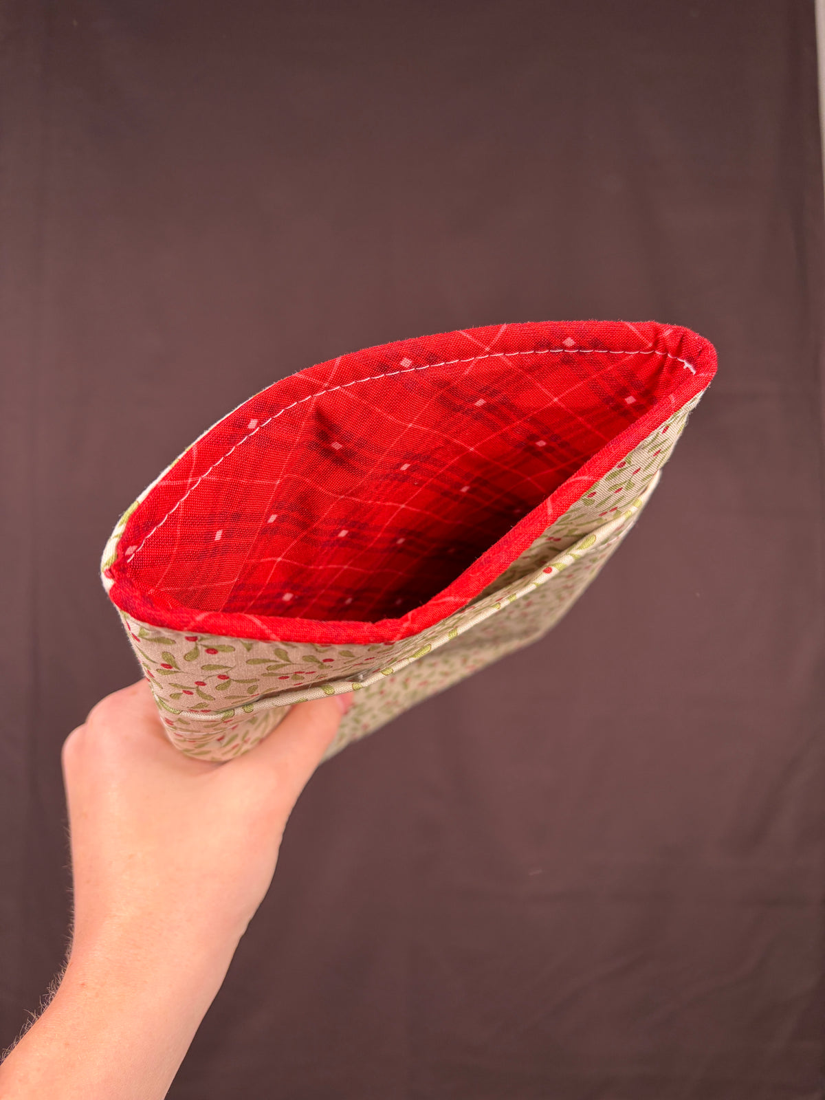 Open e-reader sleeve showing red plaid lining and cream floral outer