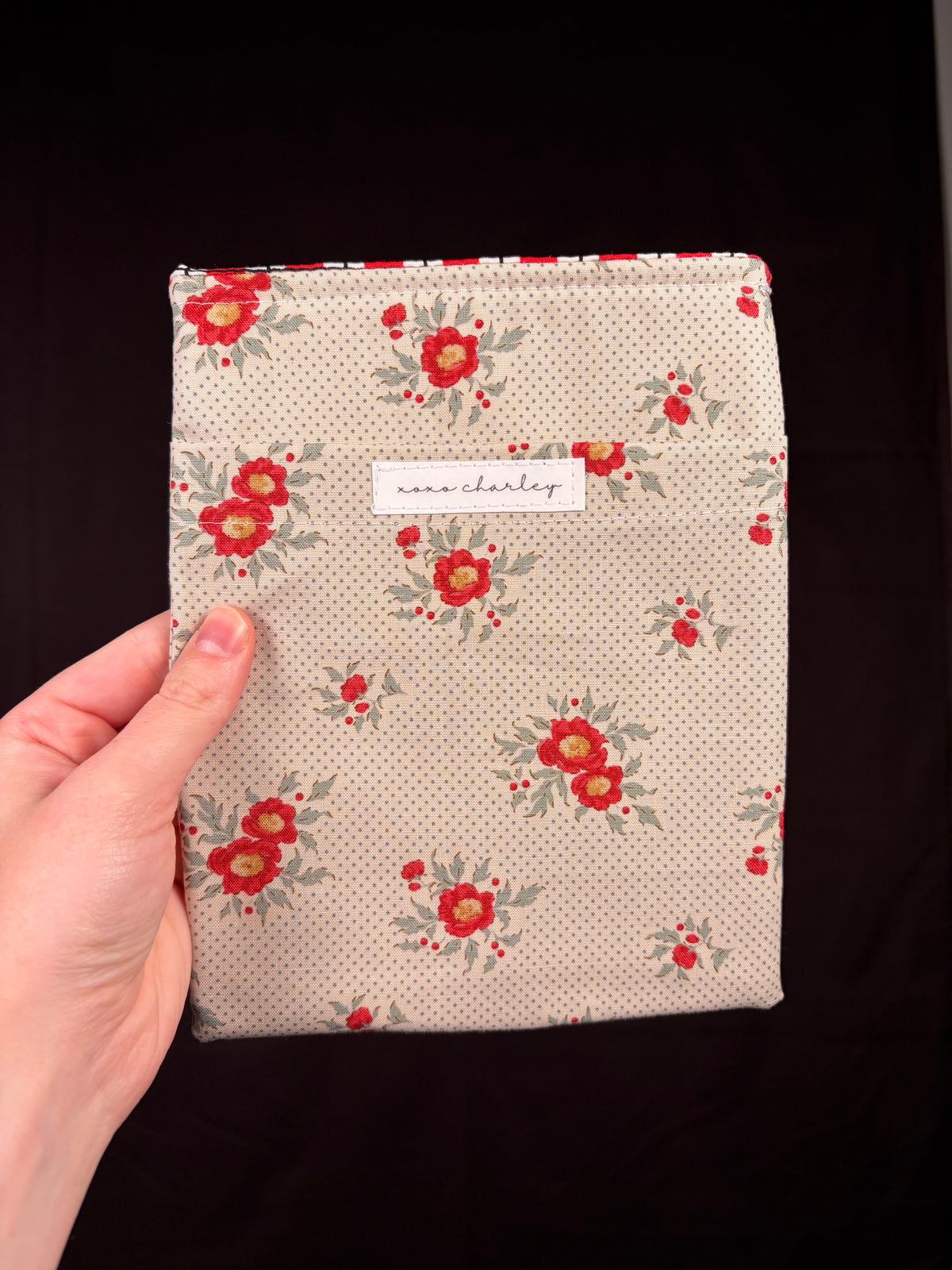 Floral e-reader sleeve with cream fabric and red flower print, front fabric patch