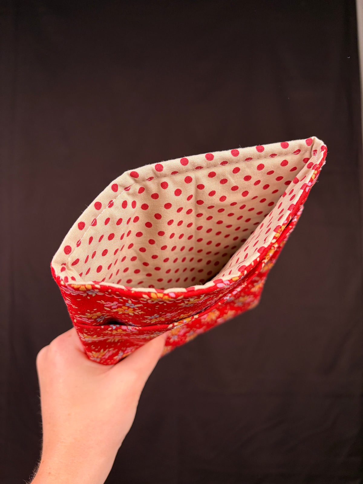 Folded e-reader sleeve lining in white with red polka dots