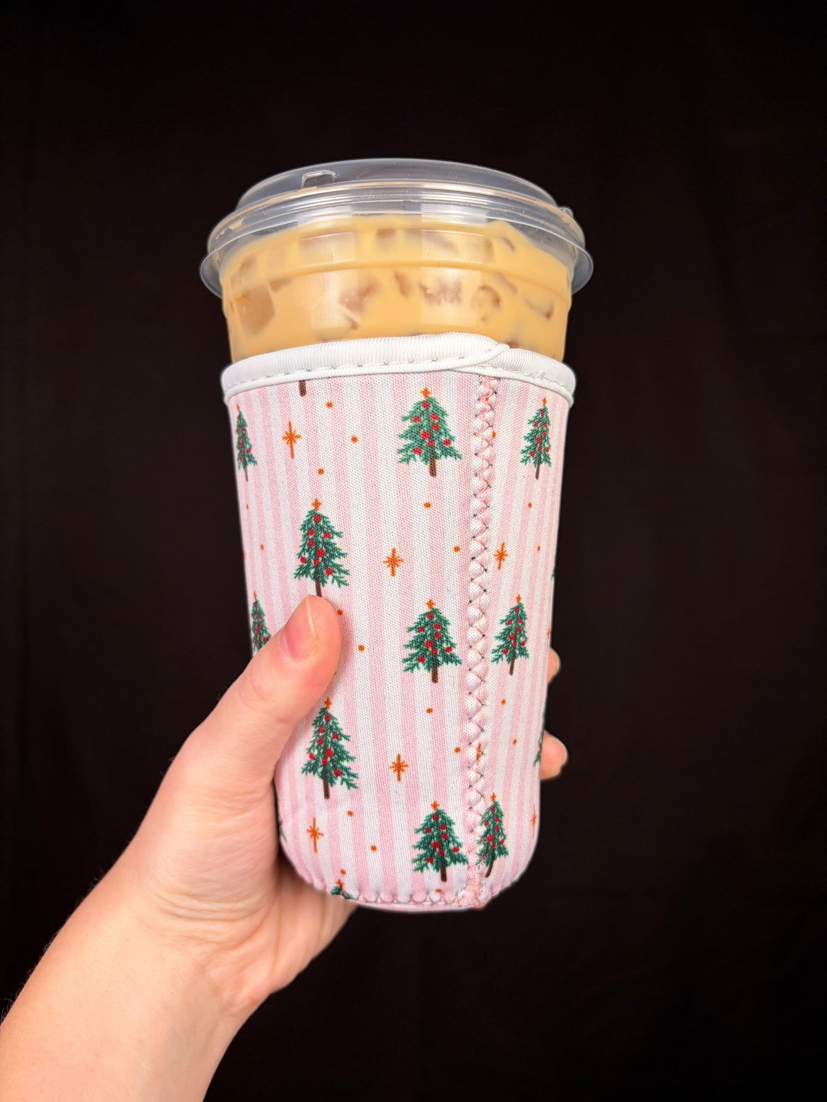 Medium pink striped cup sleeve with evergreen Christmas tree and star pattern