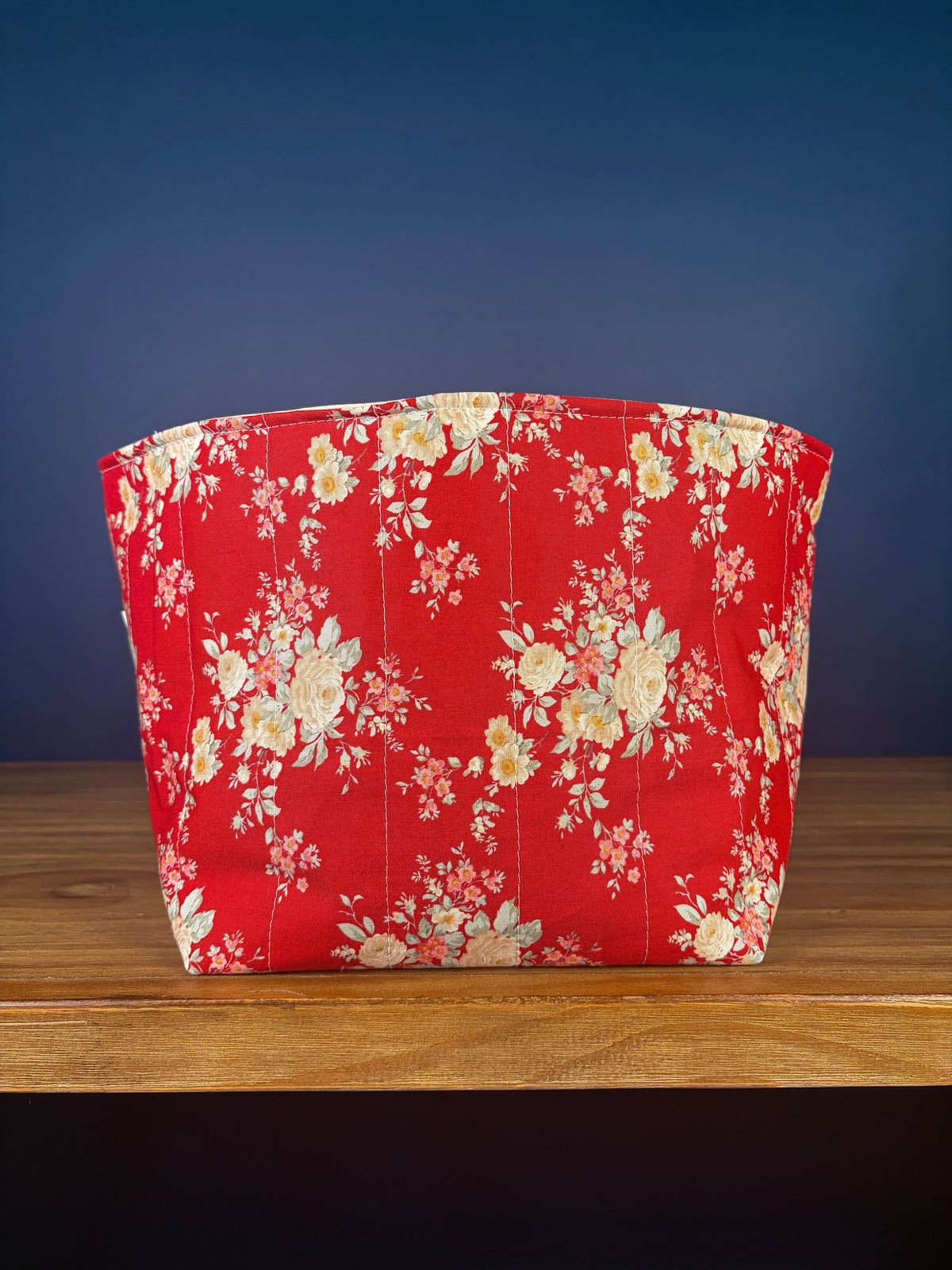 Large fabric bowl with red floral print and curved sides