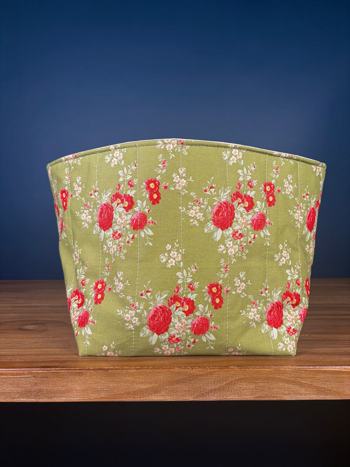 Large fabric bowl with red floral print on light green fabric