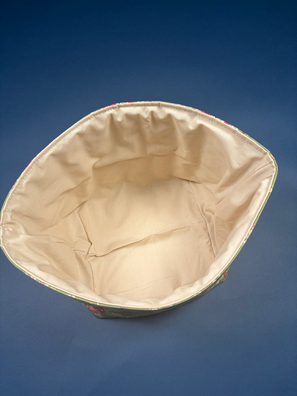 Large fabric bowl interior with beige lining and stitched rim
