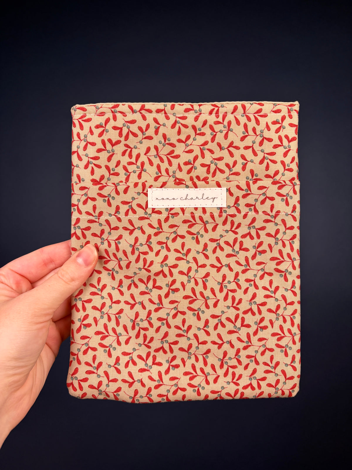 Hot Toddy e-reader sleeve, red floral fabric outer with paper label patch