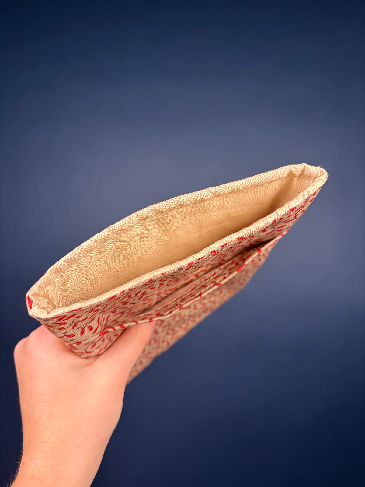 Hot Toddy e-reader sleeve showing tan interior lining and red floral trim