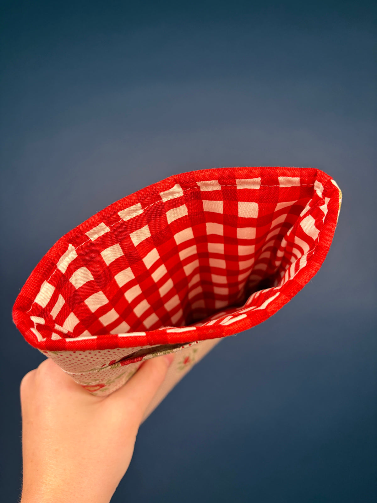 E-reader sleeve interior with red and white gingham lining and curved opening
