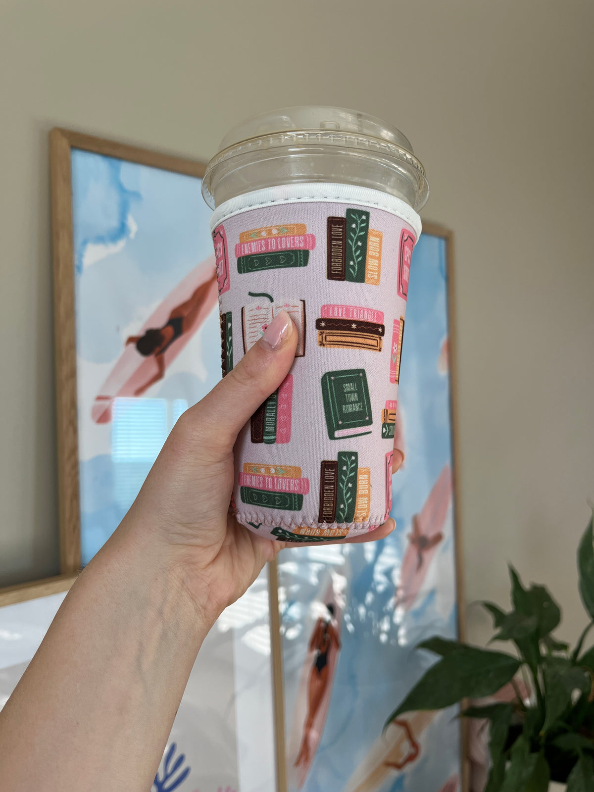 Book-print cup sleeve wrapped around a clear plastic cup