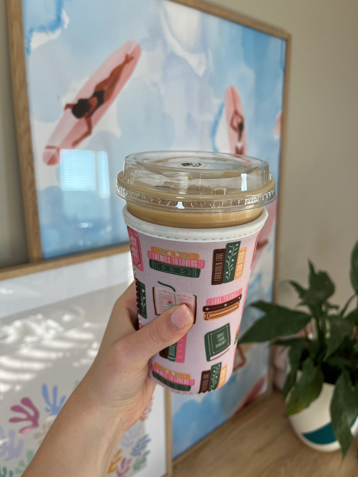 Book-spine cup sleeve with multicolor library-style cover designs