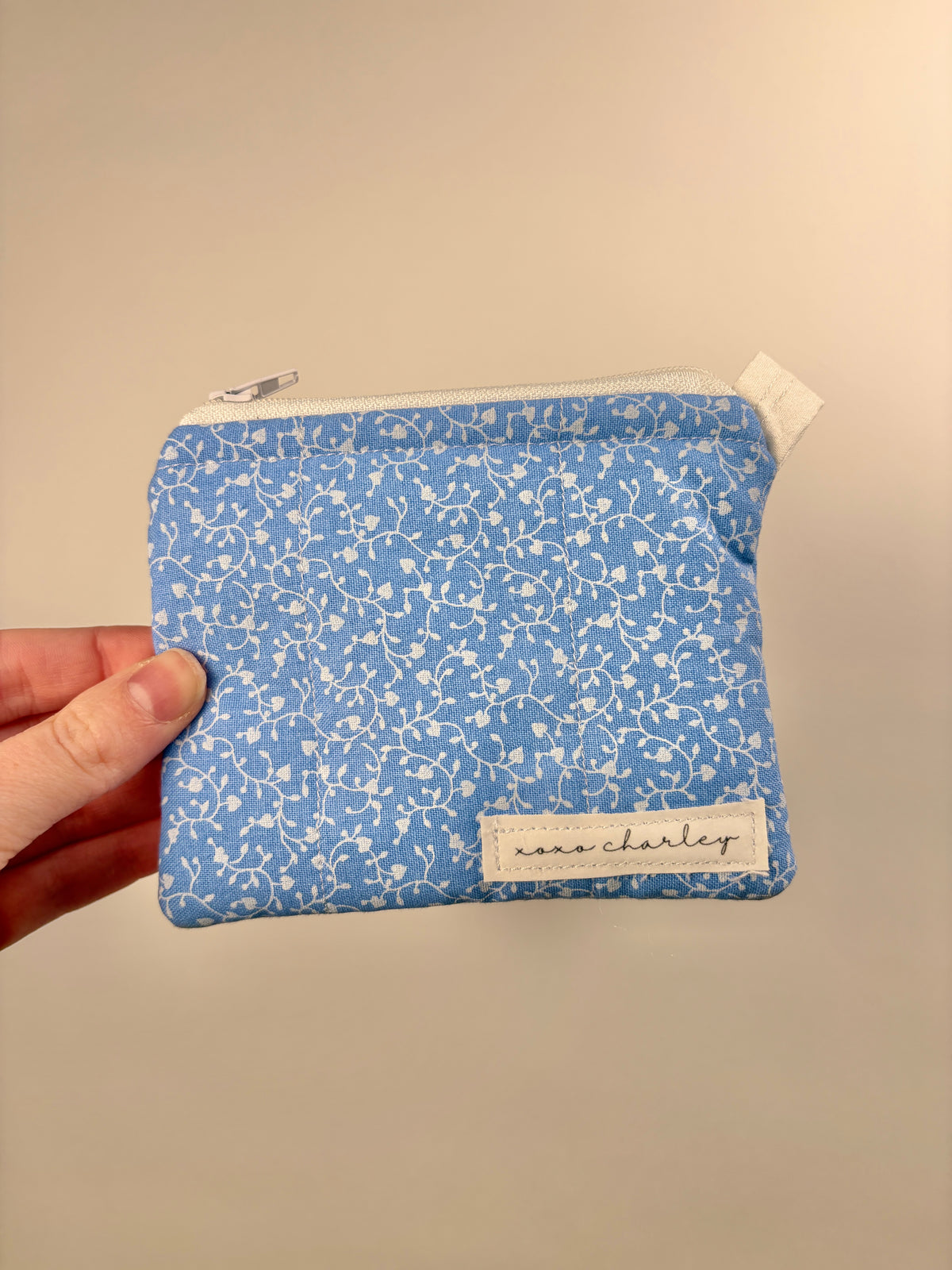 Blue keychain wallet with tiny white hearts, zip pouch, marc charlett label