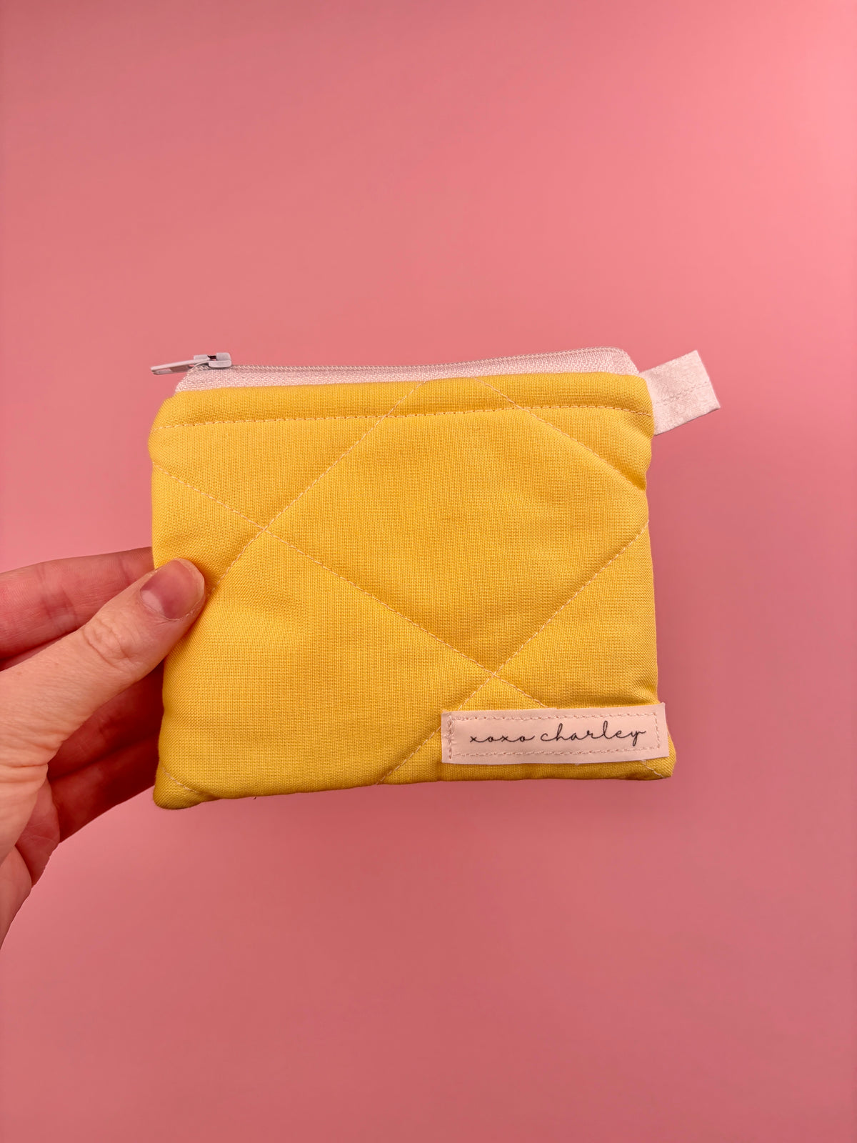 Yellow quilted keychain wallet with zipper and small metal keyring at top
