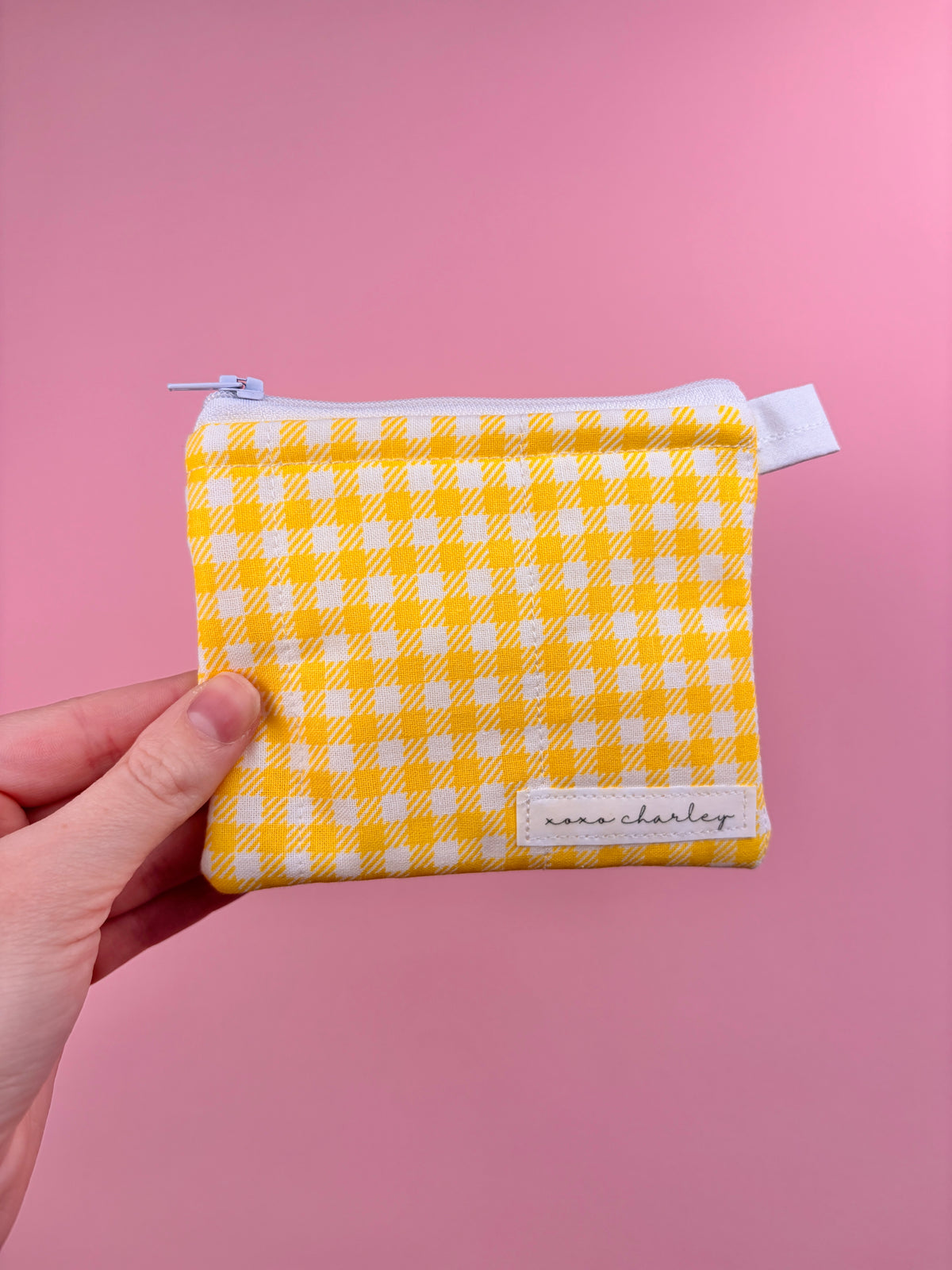Yellow gingham zip pouch wallet with small stitched front label