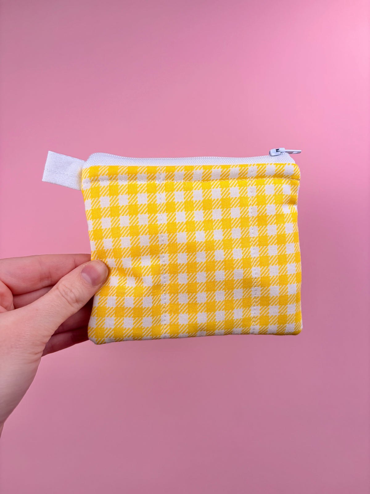 Yellow gingham zip pouch wallet with top zipper and fabric loop tab