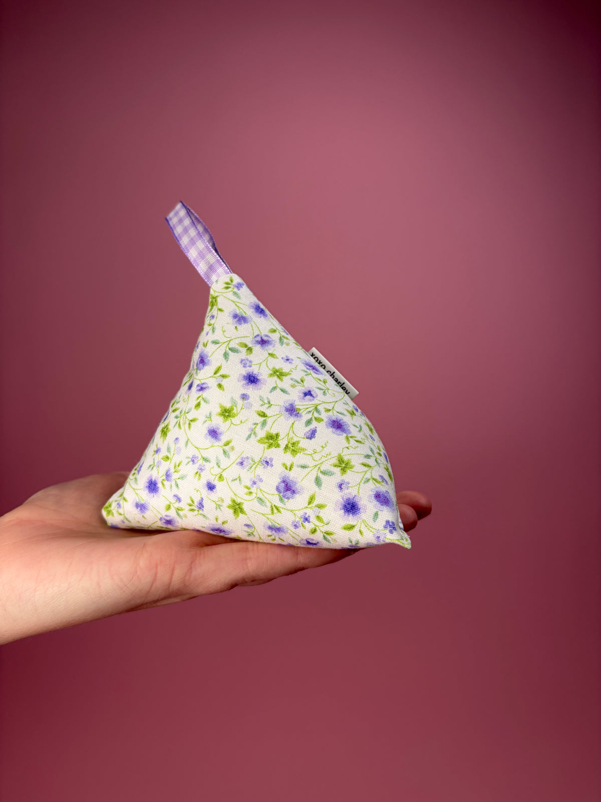 Floral-patterned weight with folded ribbon tail, blue gingham and purple flower print