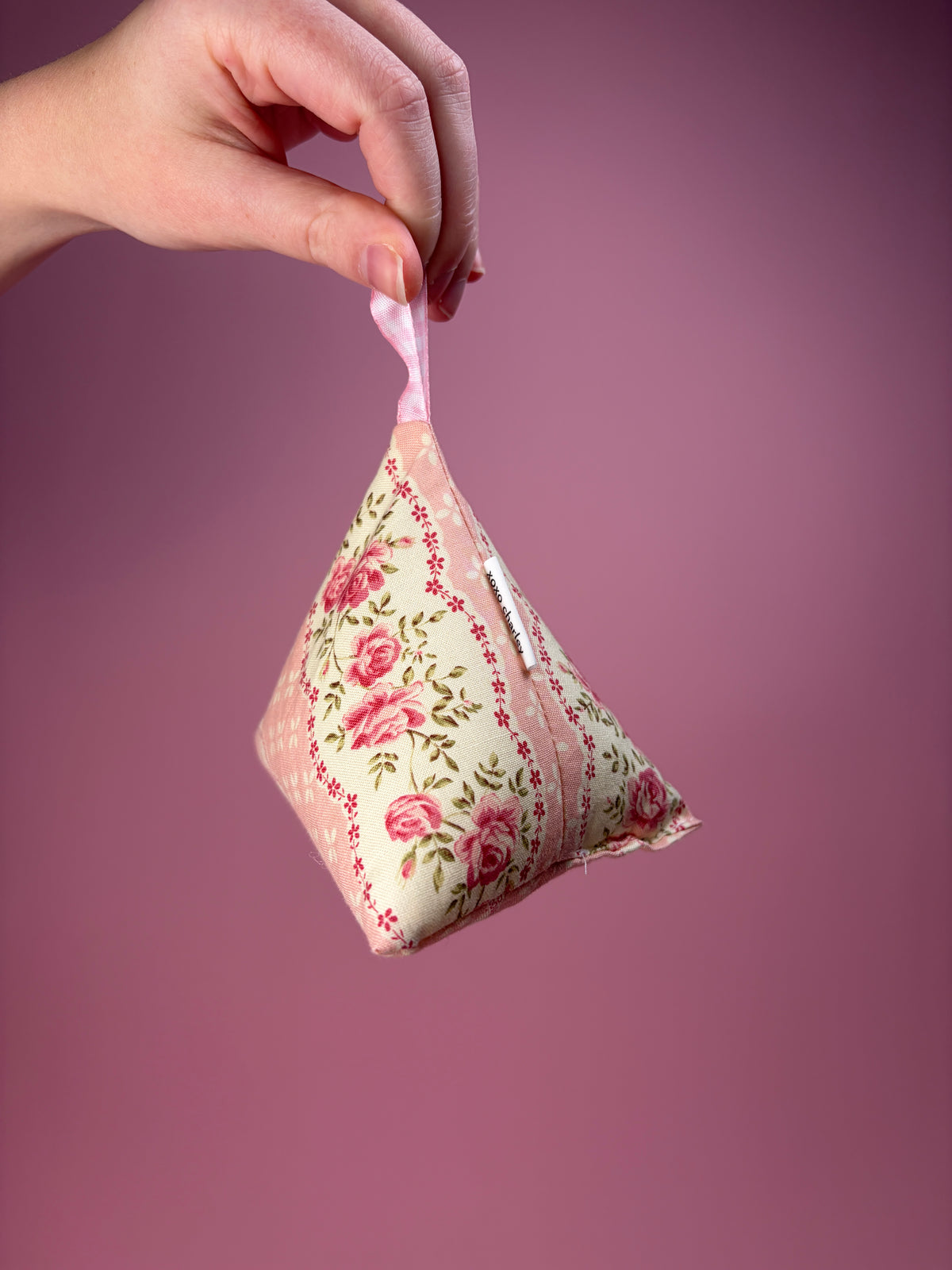 Floral fabric hanging weight pouch with pink ribbon loop and roses pattern