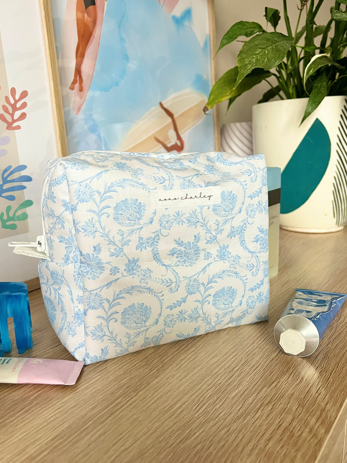 Light blue floral makeup bag, front view with zipper