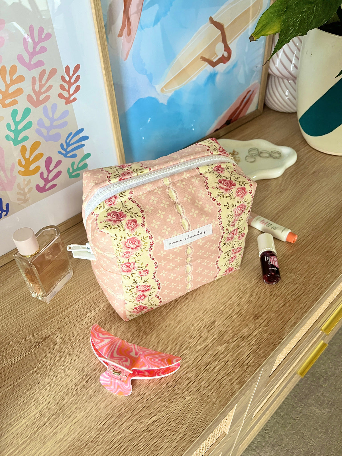 Pink floral medium makeup bag with white zipper and trim
