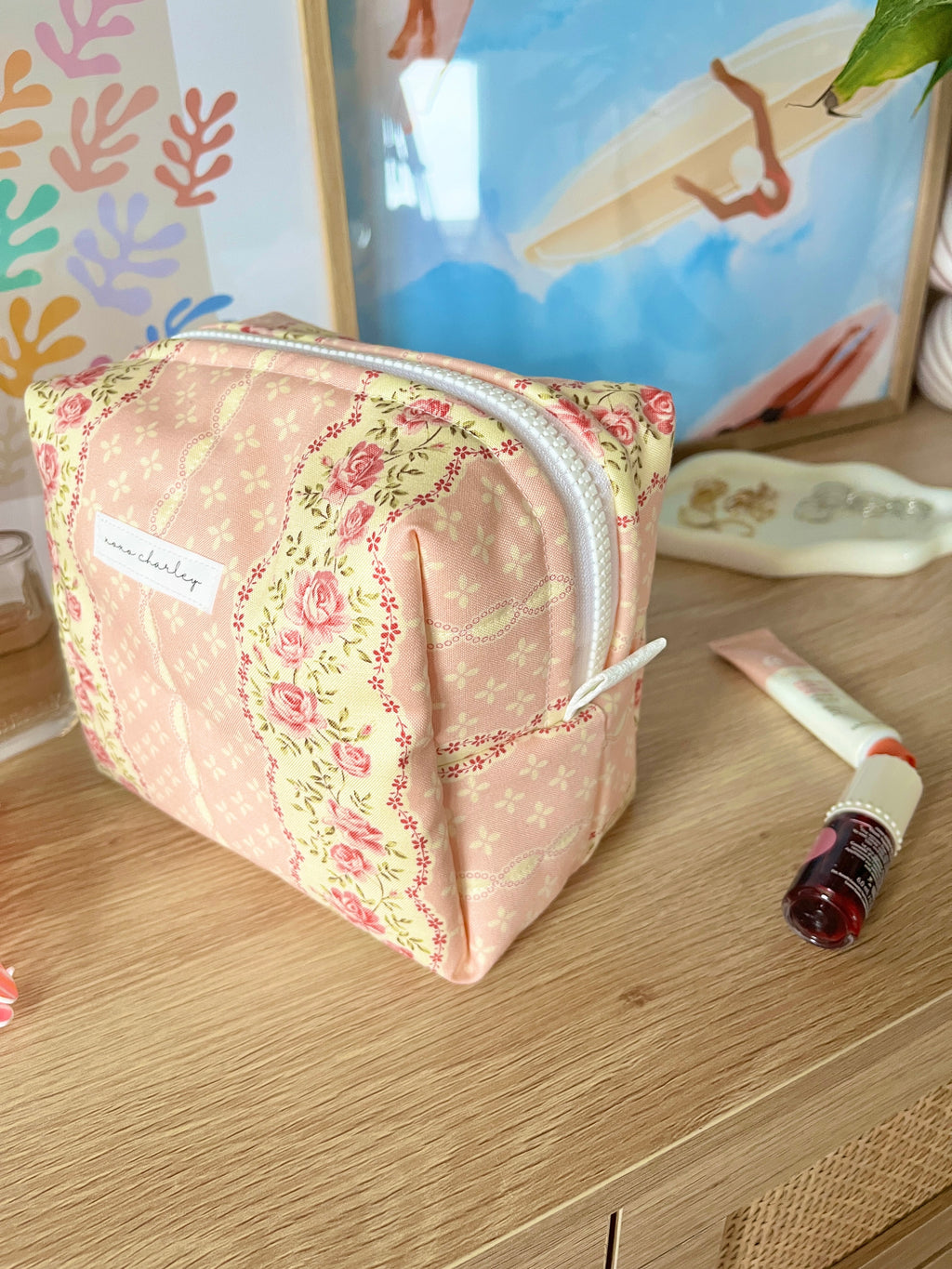 Pink floral medium makeup bag, front view with white zipper pull