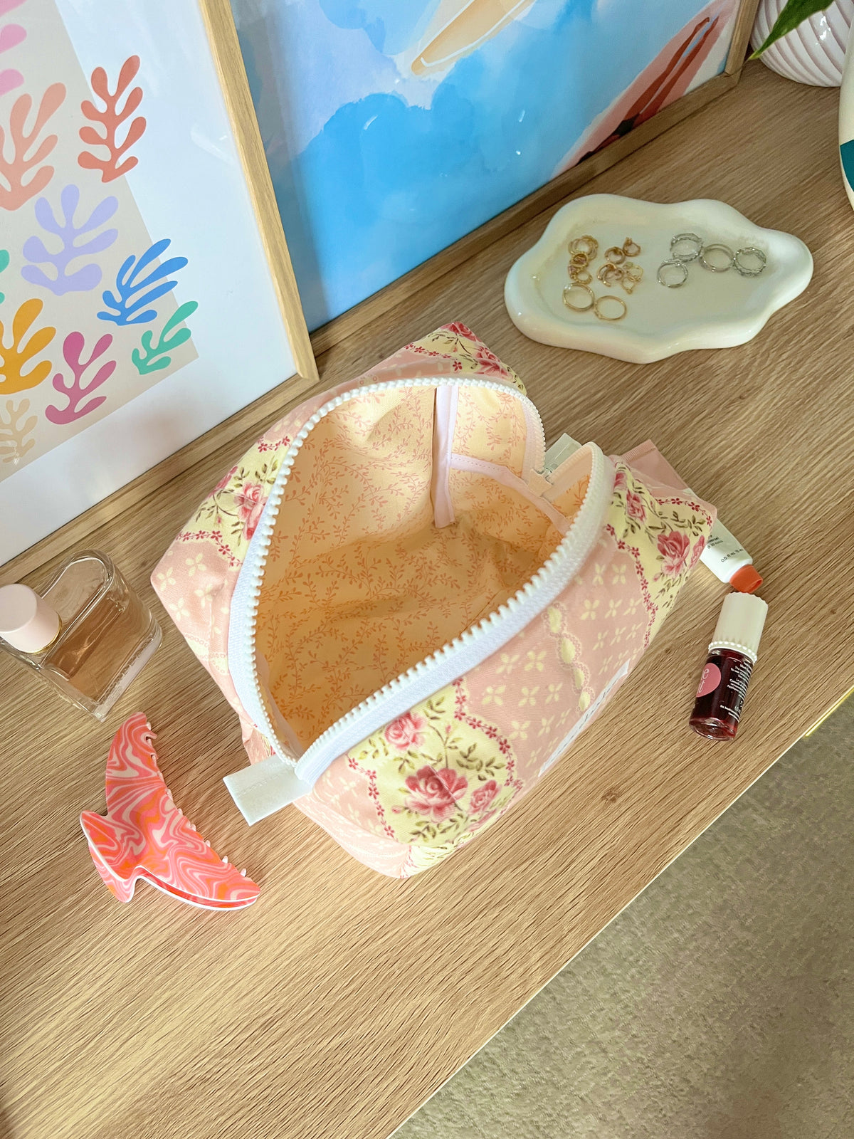 Pink floral medium makeup bag open, tan interior with white trim