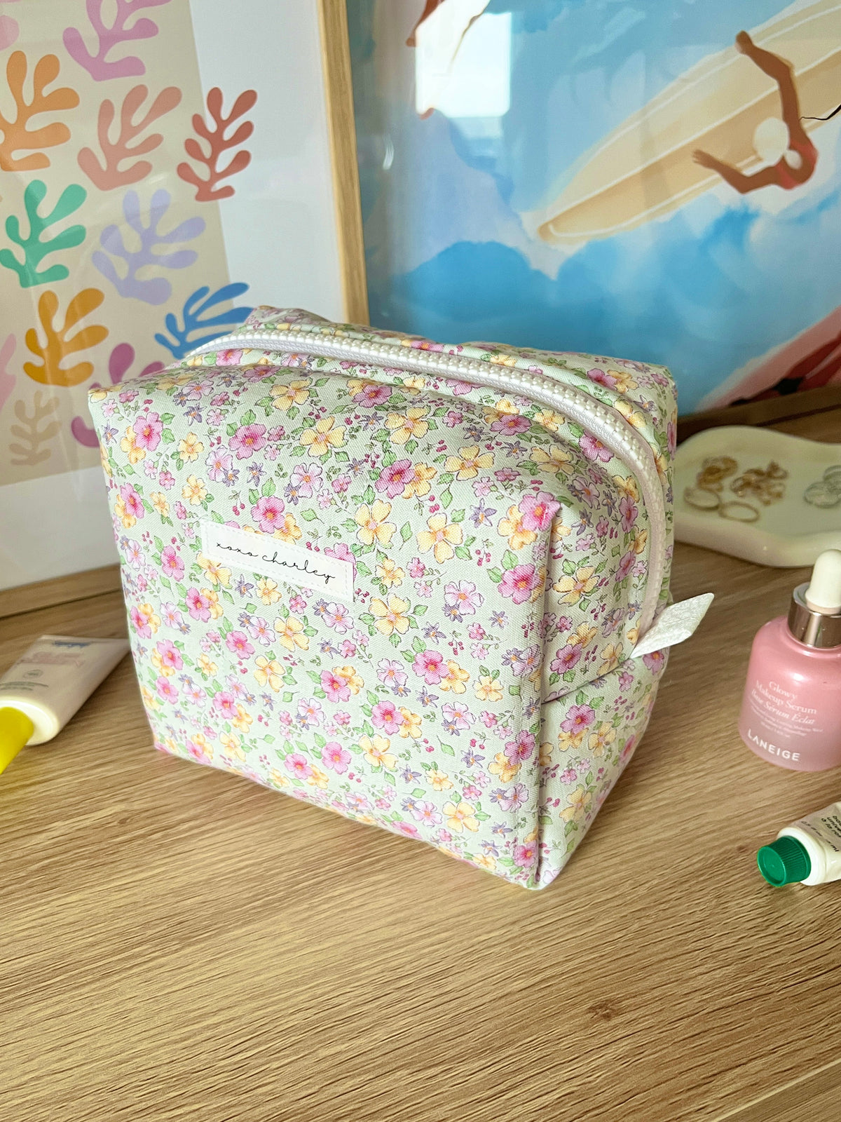Primrose medium makeup bag with floral print and front label patch