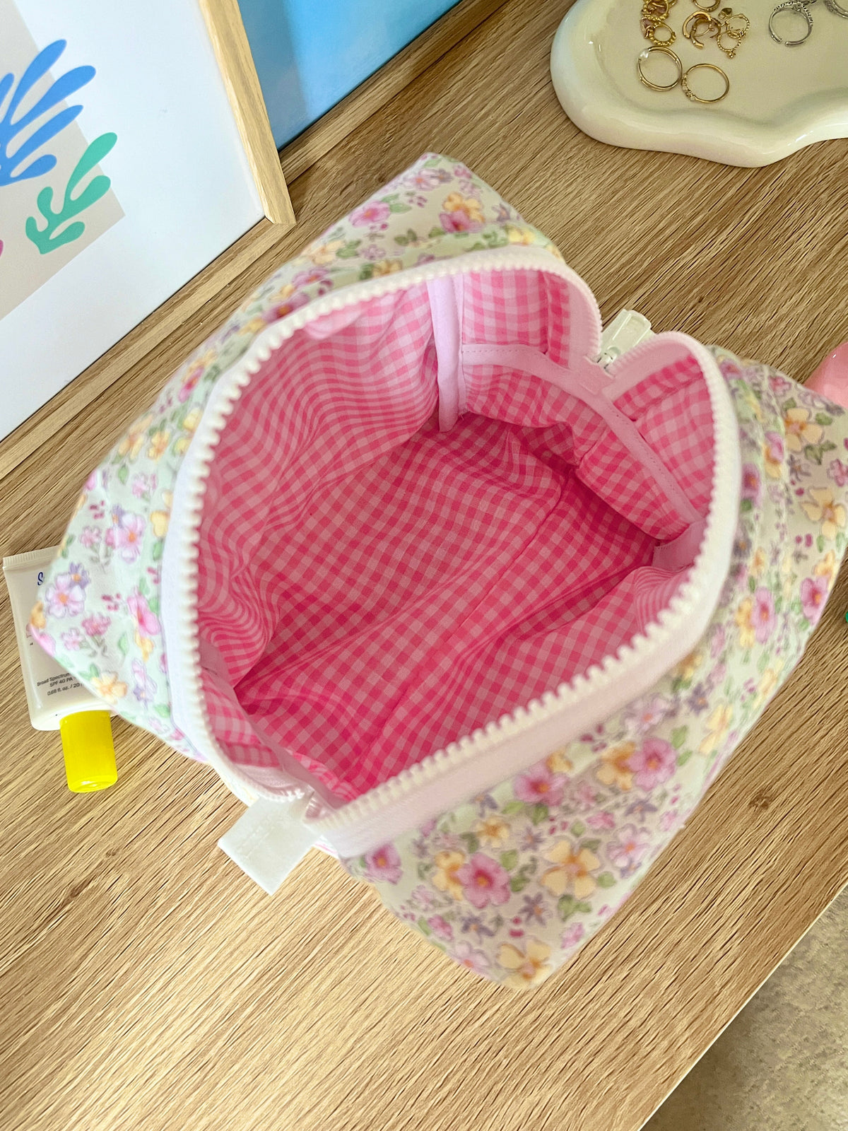Primrose medium makeup bag open with pink gingham interior and white trim