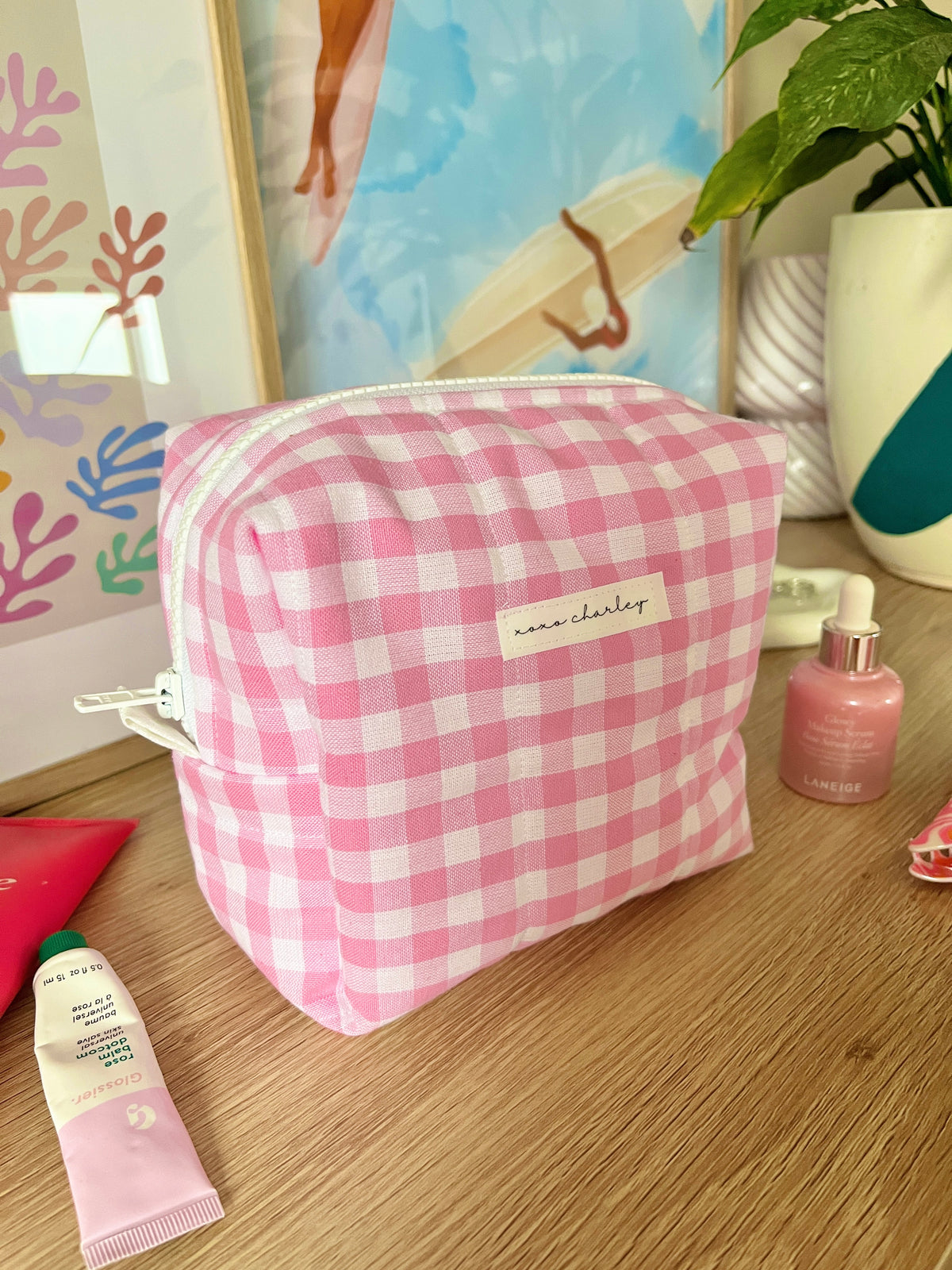 Pink gingham makeup bag with rectangular shape and stitched top zipper