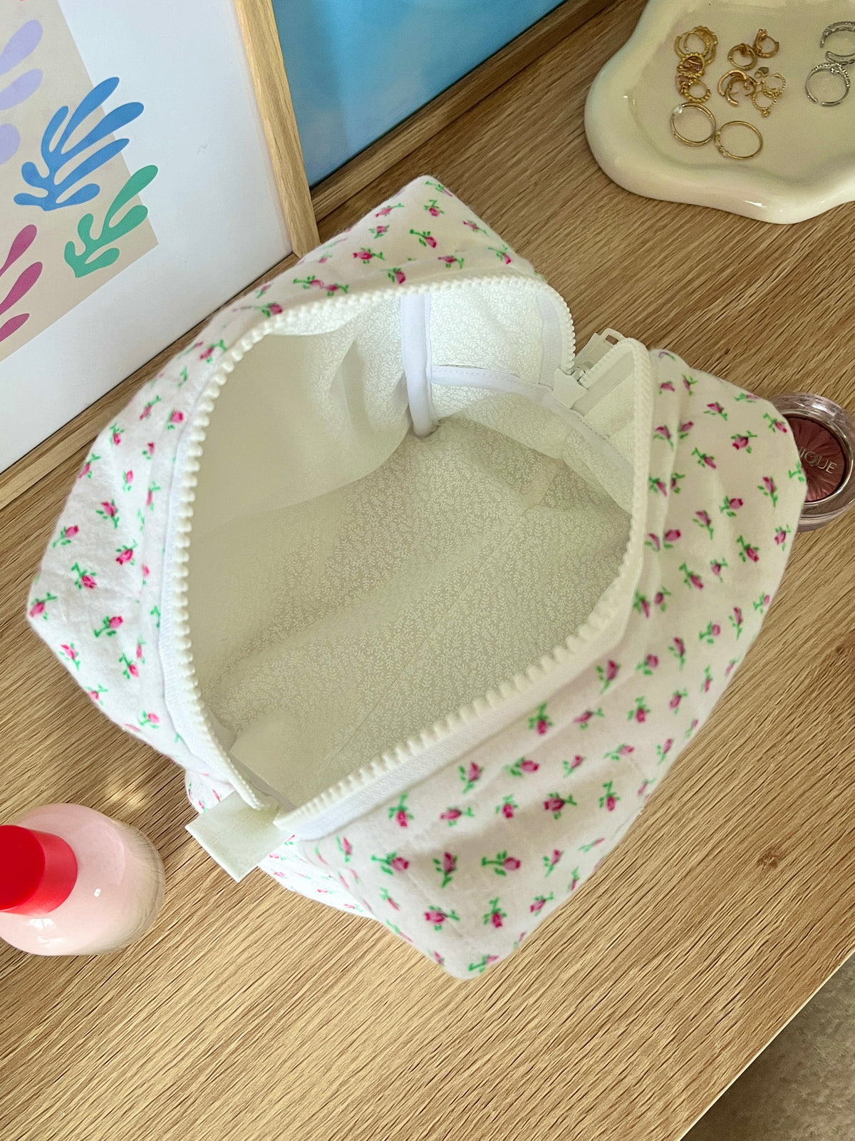 Mini rose makeup bag open top, white floral exterior with lined interior pocket