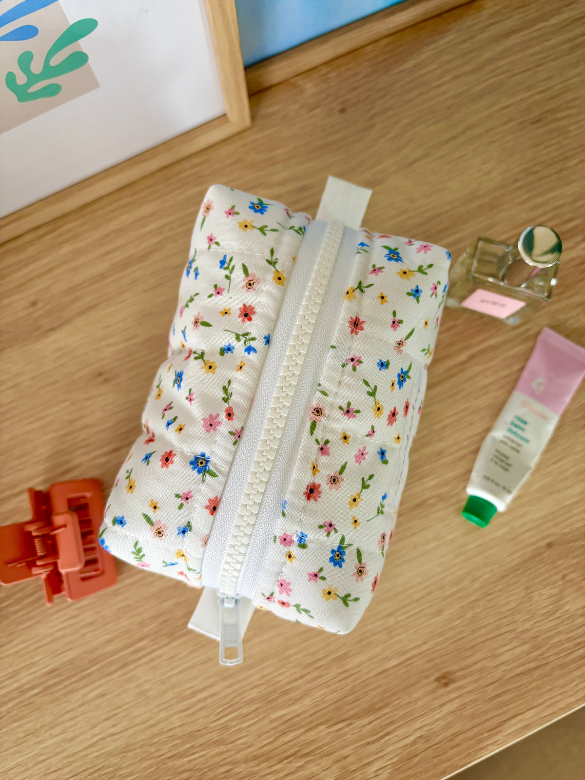 Mini white-and-colorful flower print makeup bag with open top zipper