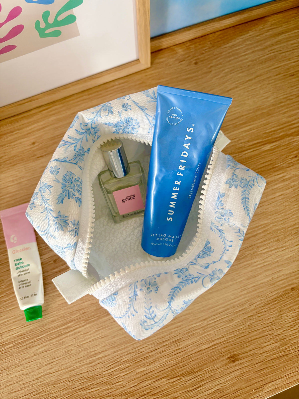 Vintage blue mini makeup bag opened with light interior lining and blue floral outer fabric.