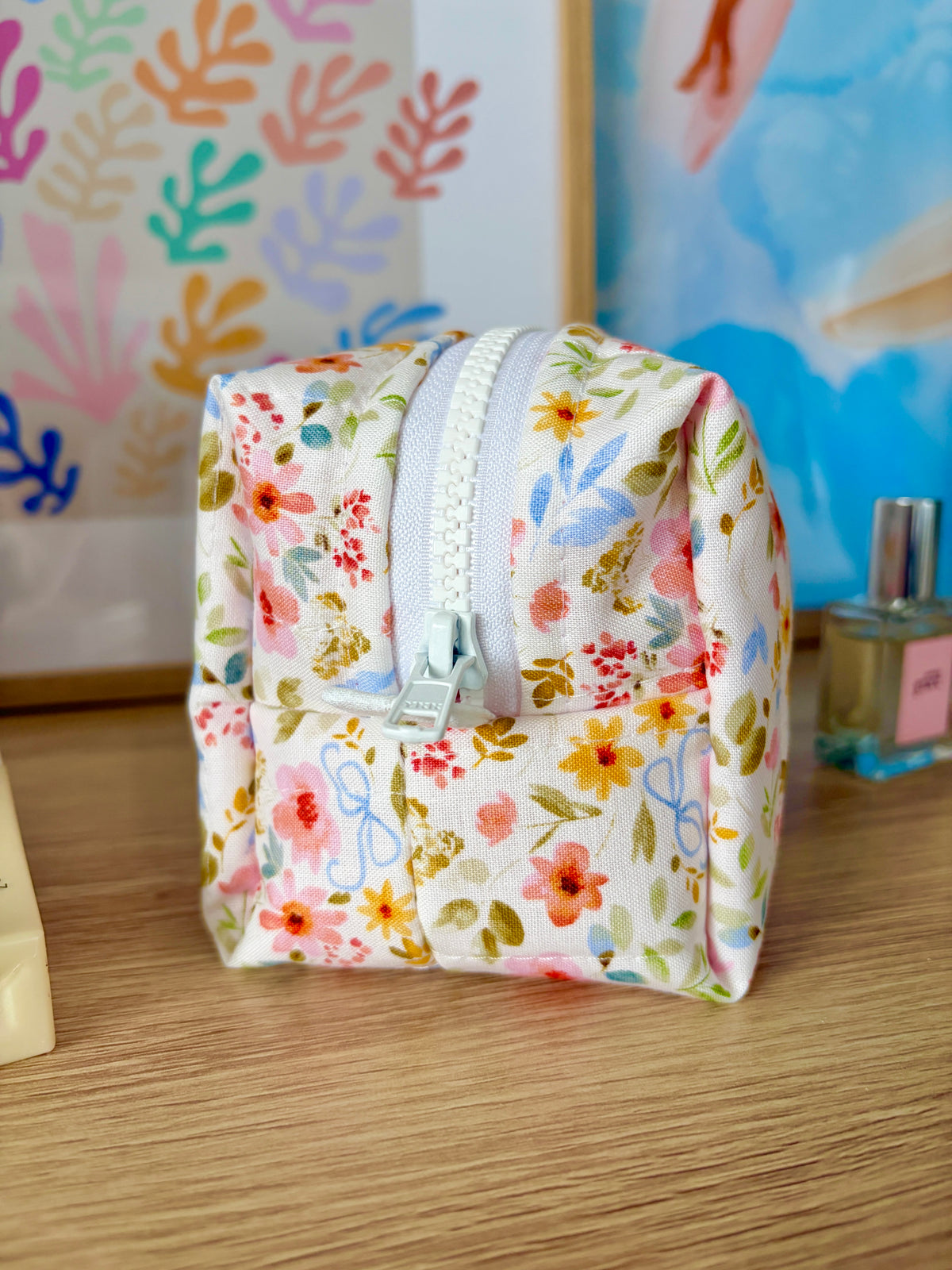 Bright floral mini makeup bag, white zipper detail on the side, compact pouch