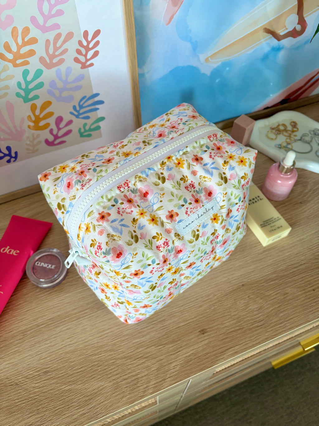 Floral large makeup bag with white base, multicolor flowers, and light blue zipper