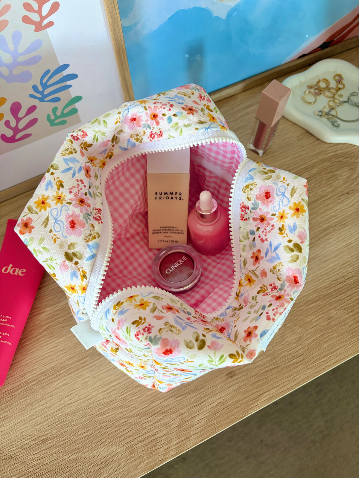 Open floral large makeup bag, white with colorful flowers, pink gingham lining and zipper