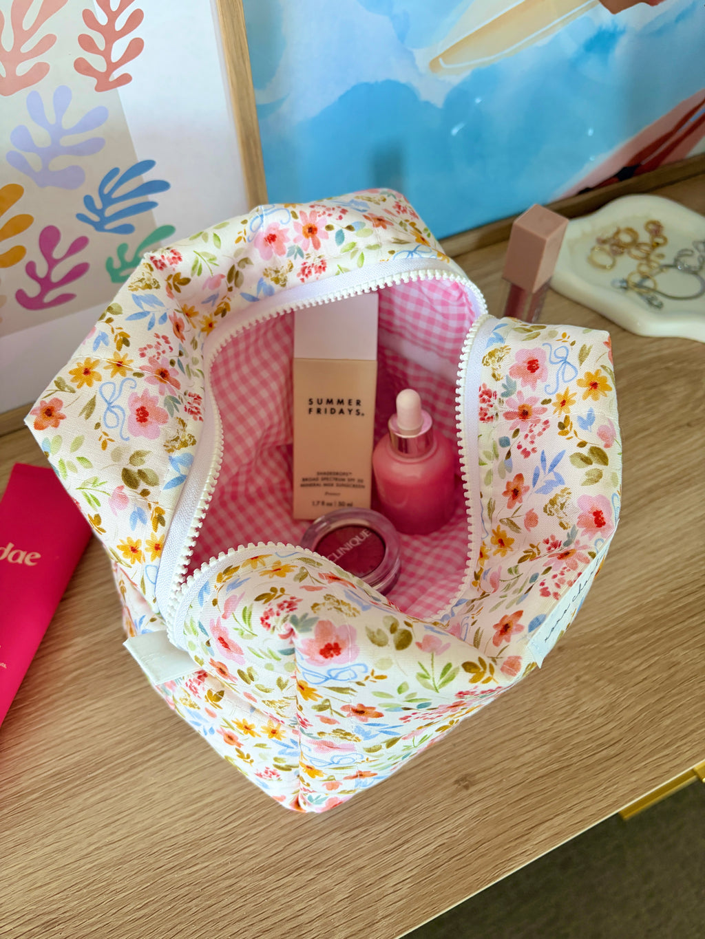 Floral large makeup bag open, white with colorful flowers, pink gingham interior lining