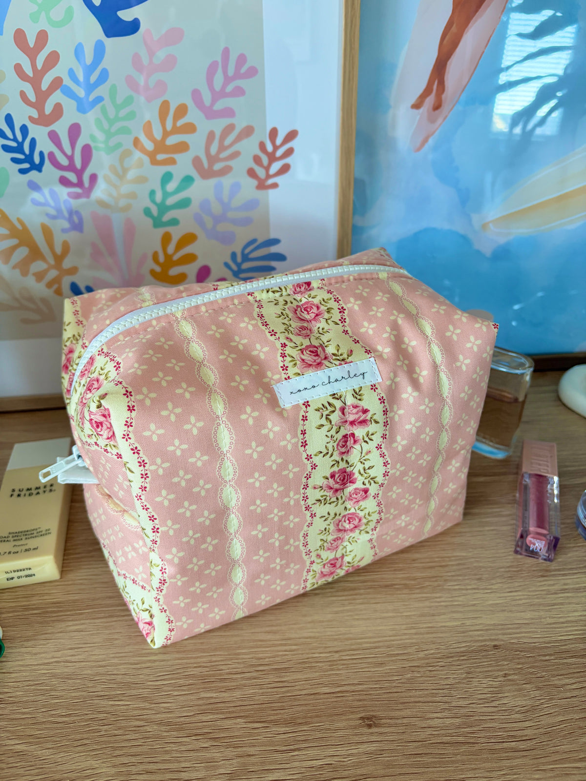 Large pink floral makeup bag, zip-top design with light blue zipper trim