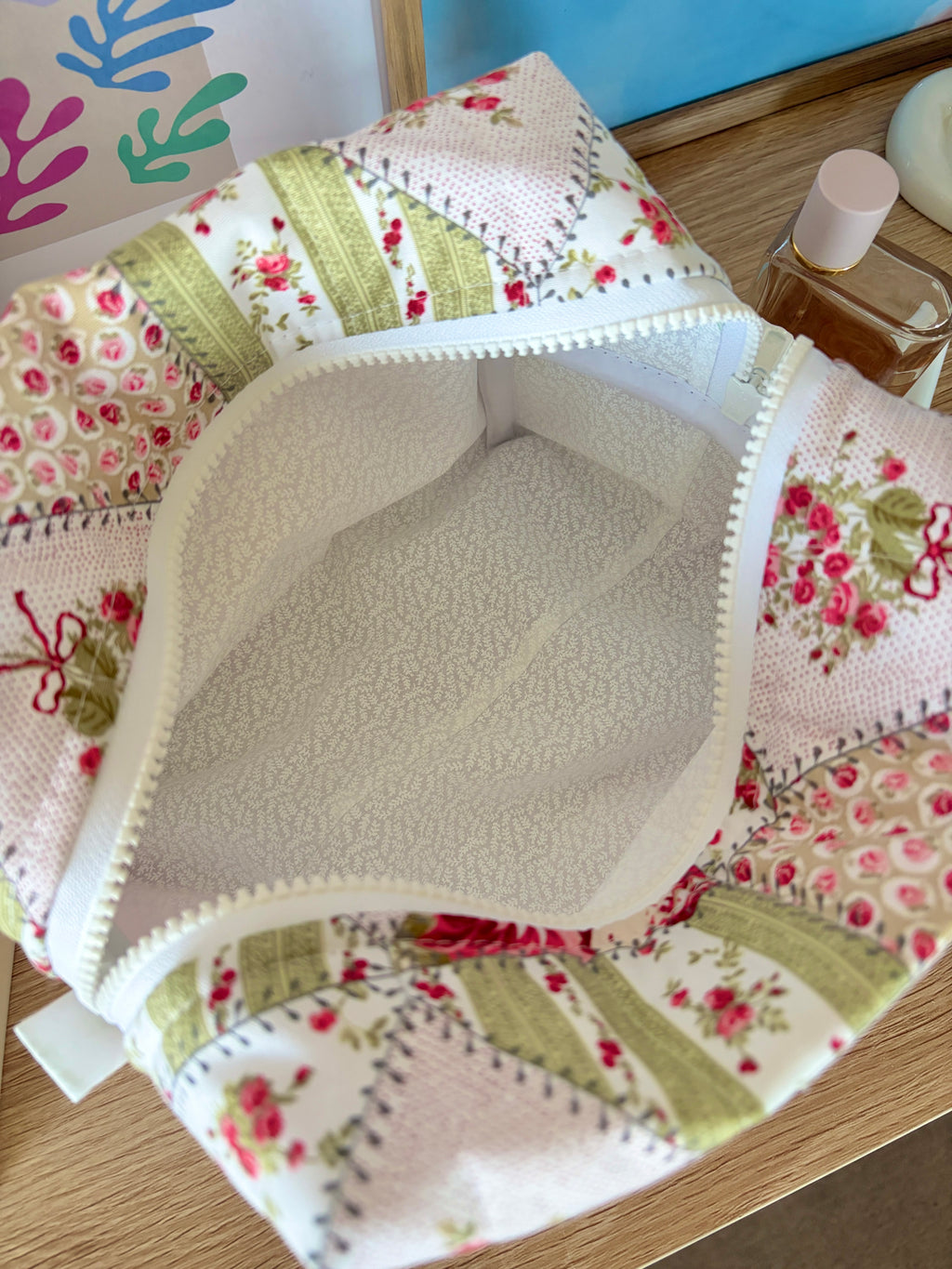 Large floral patchwork makeup bag interior with textured lining and zipper edge
