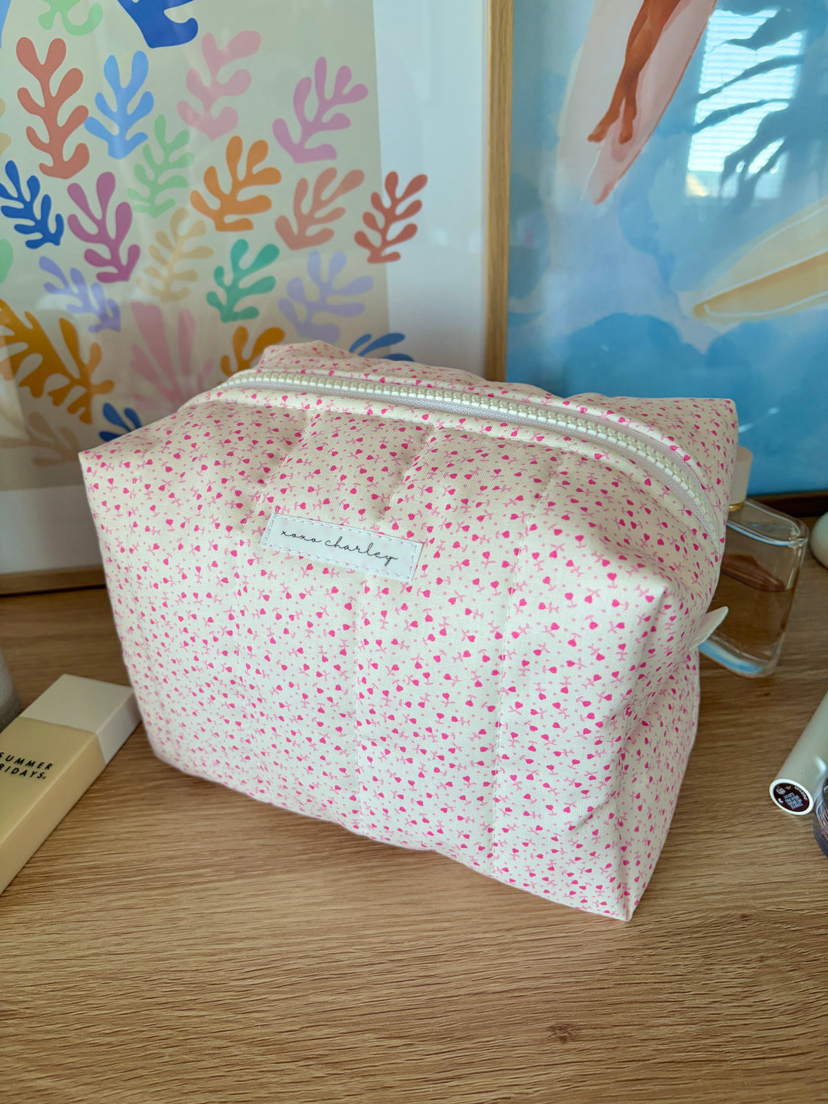 Large pink makeup bag with tiny heart print and silver front zipper