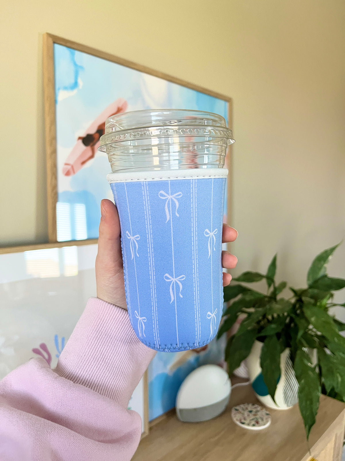 Medium blue cup sleeve with white bow embroidery and vertical stitched stripes