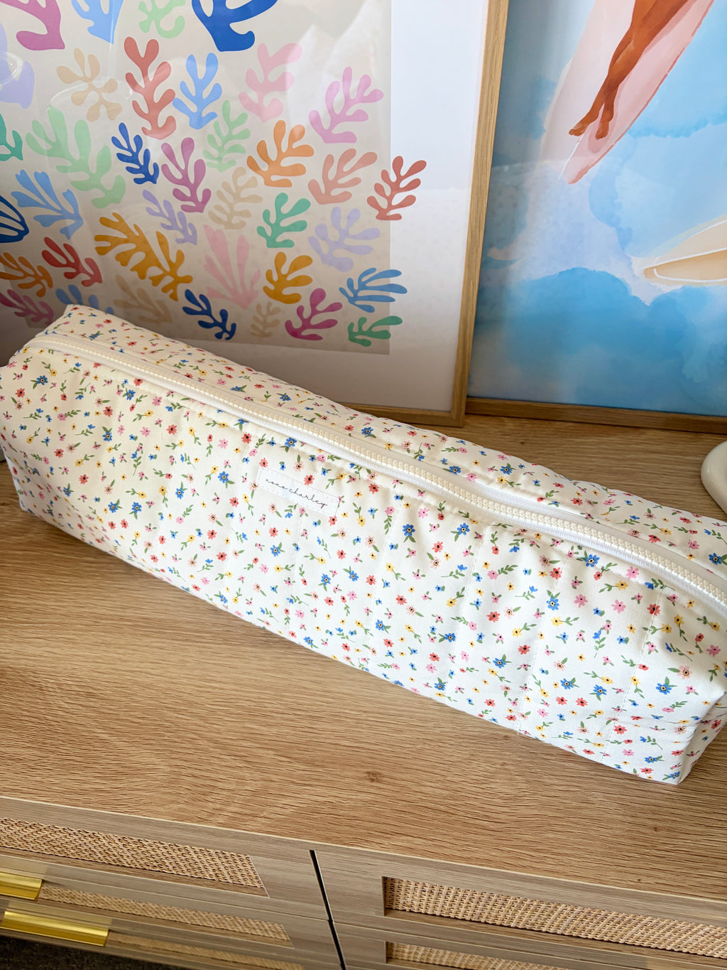 Colorful floral hair tools pouch with zip closure on white fabric