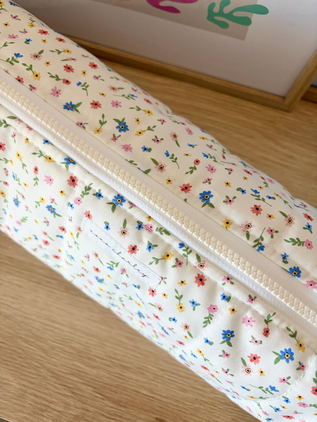 White floral hair tools bag with long zipper and multicolor tiny flower print