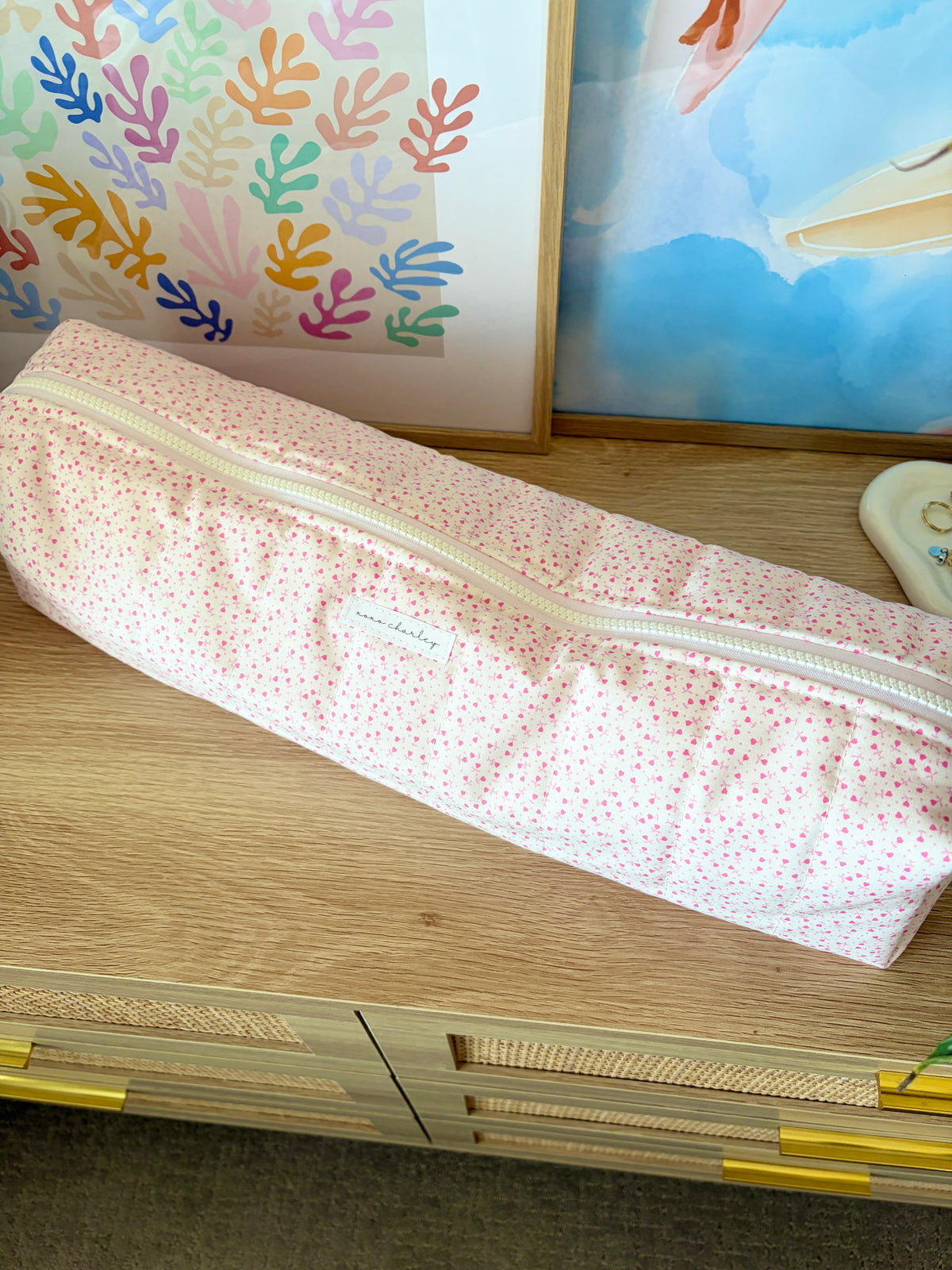 Pink heart hair tools bag with light background and long zipper closure