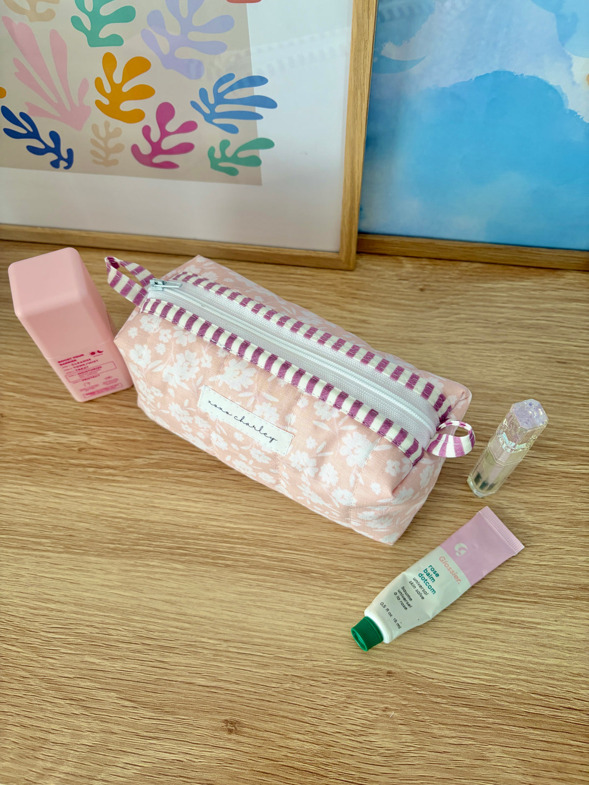 Floral colorblock zip-top bag with purple trim, light pink floral body and bow handle