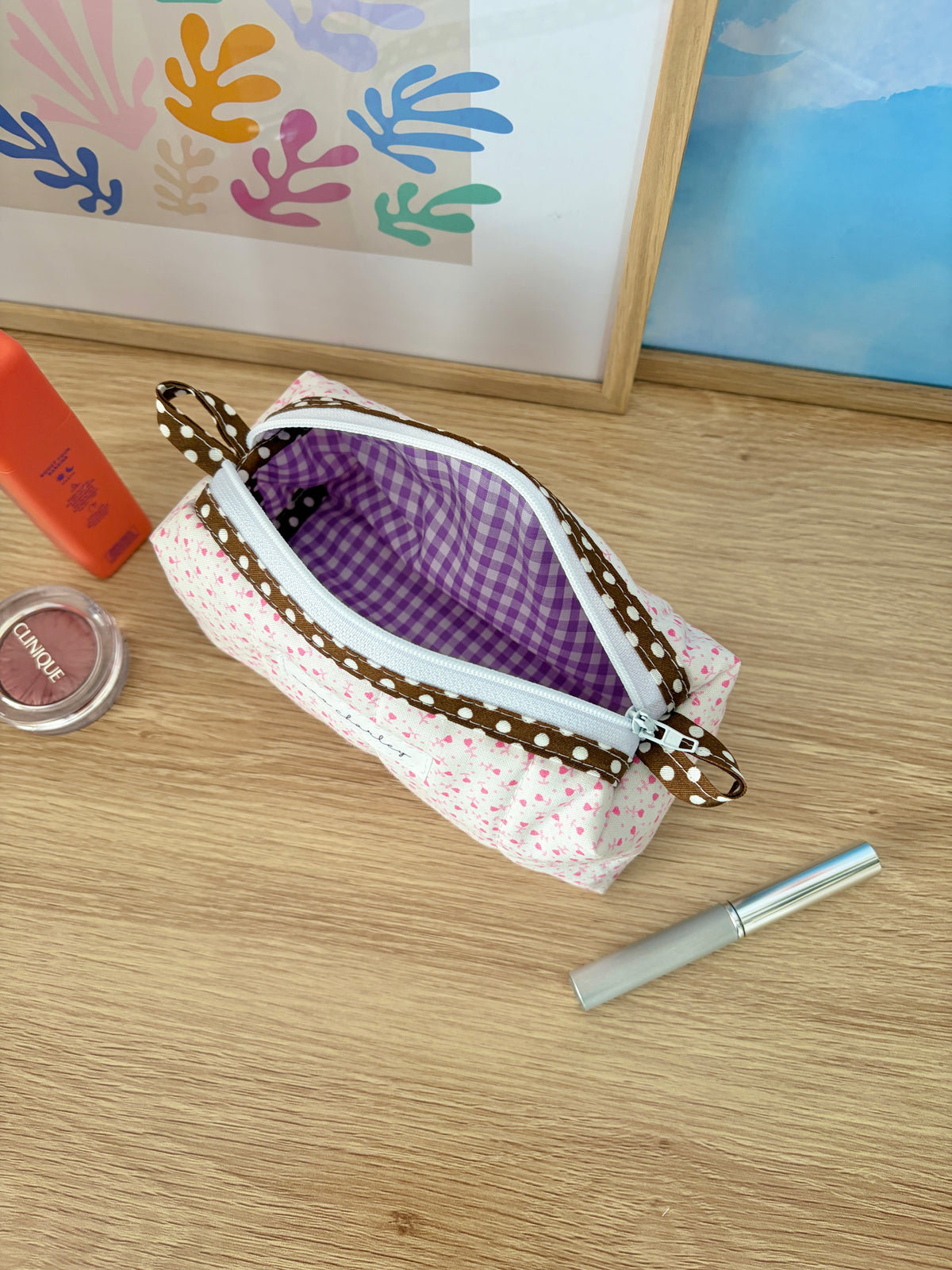 Pink heart-print zipper pouch with brown polka-dot trim and purple gingham lining