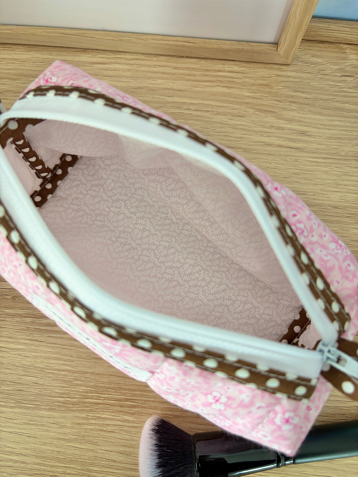Pink glitter bag interior with turquoise zipper edge and brown polka trim