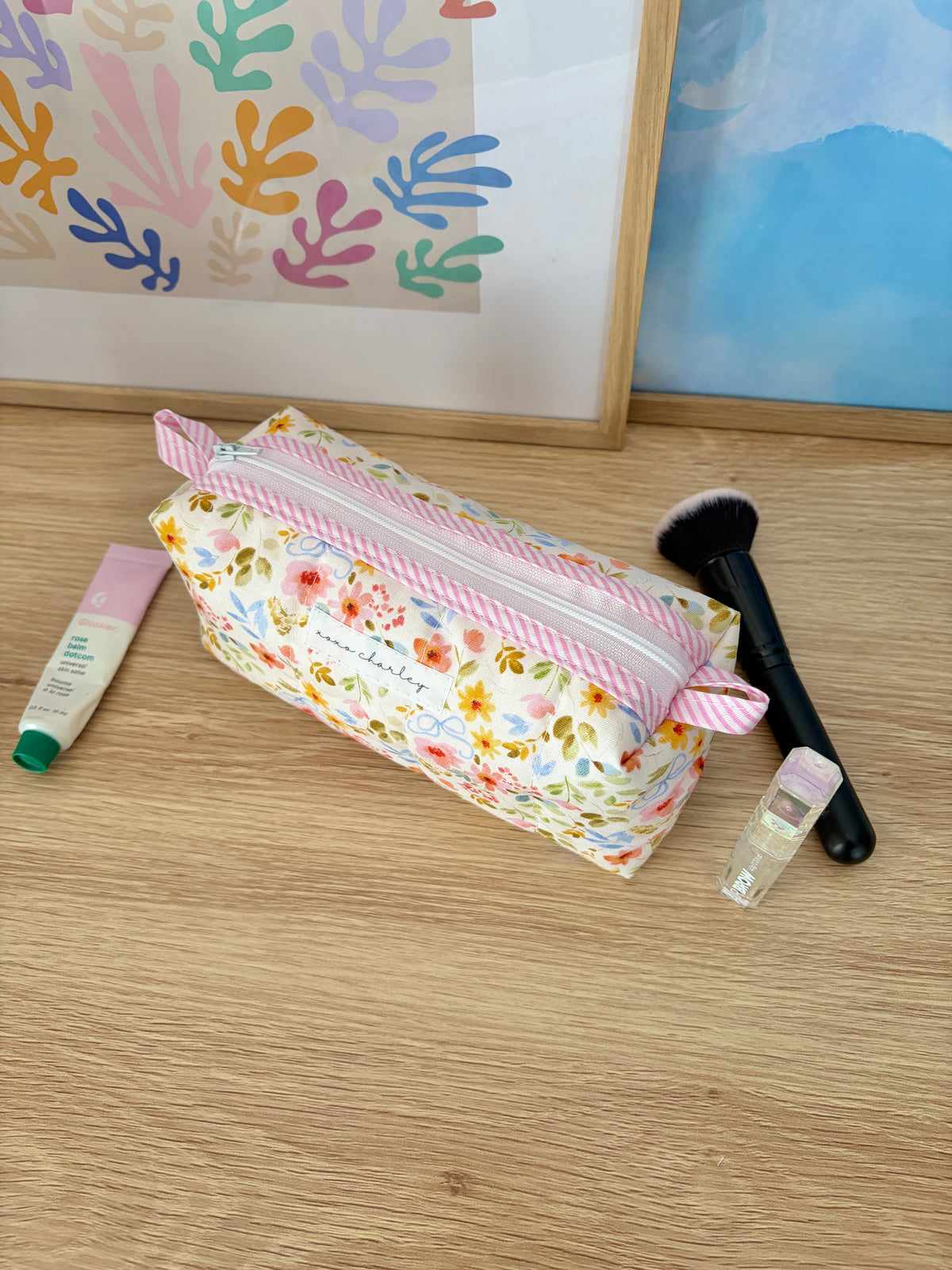 Floral colorblock zippered pouch bag with pink-and-white striped trim and tie bow
