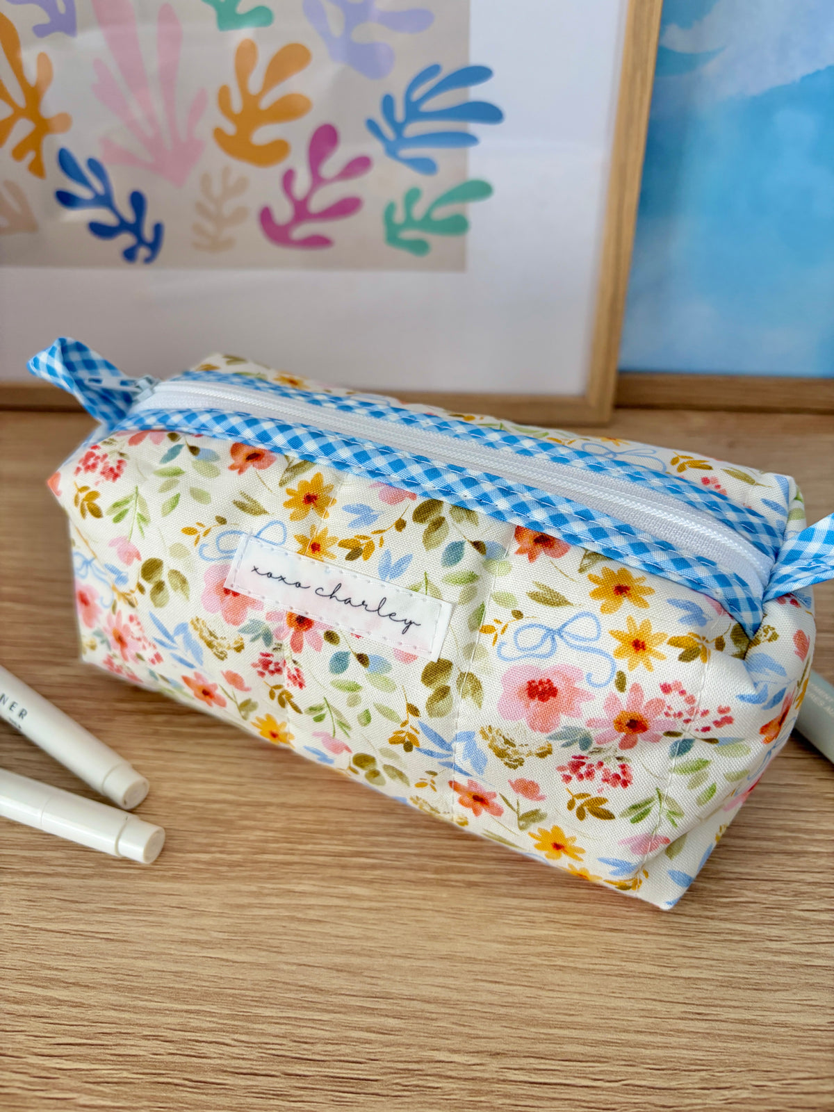 Floral colorblock zip bag with blue gingham trim and bow-tied side detail