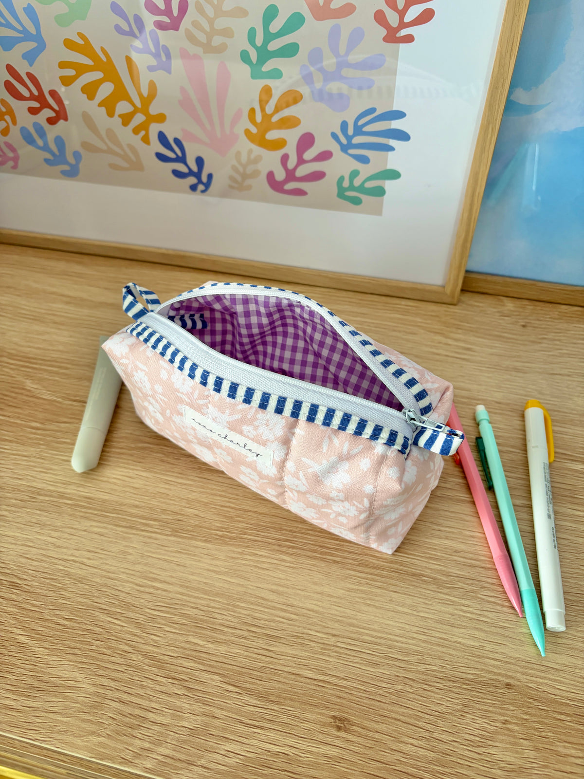 Floral zip pencil pouch with purple gingham interior and blue-and-white trim