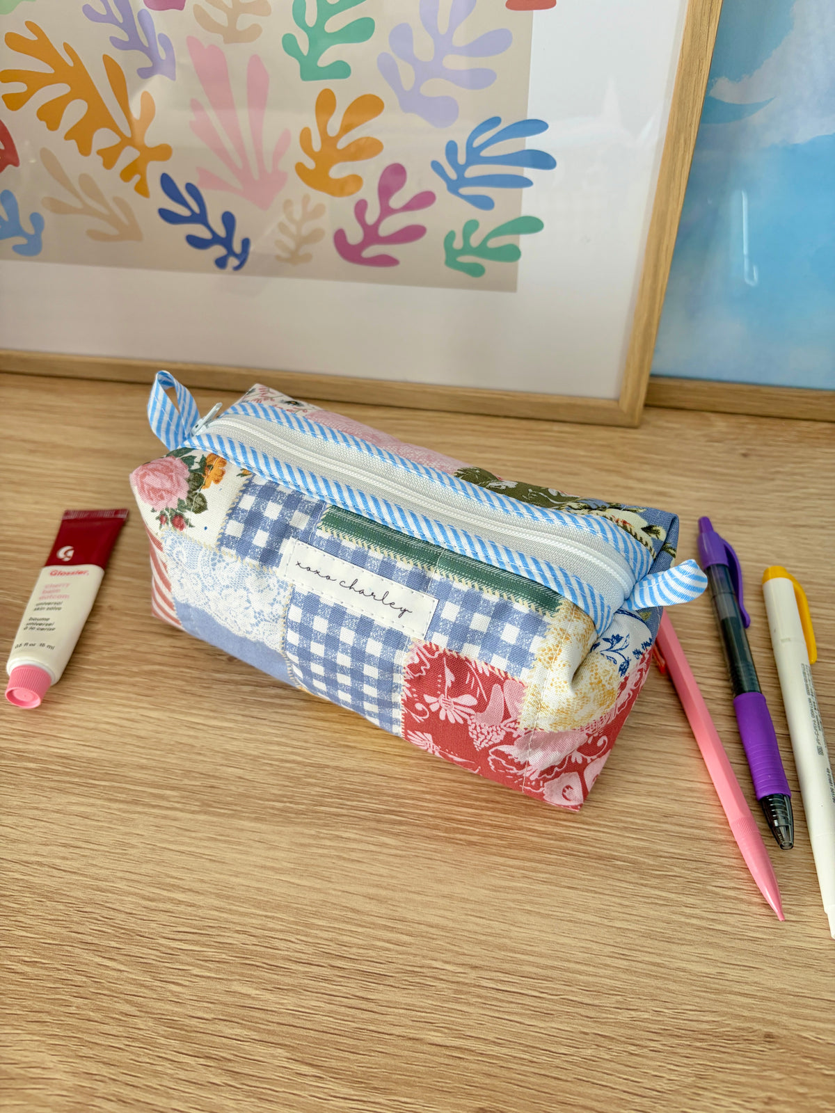 Colorblock picnic bag with blue gingham panels and floral trim, zippered pouch