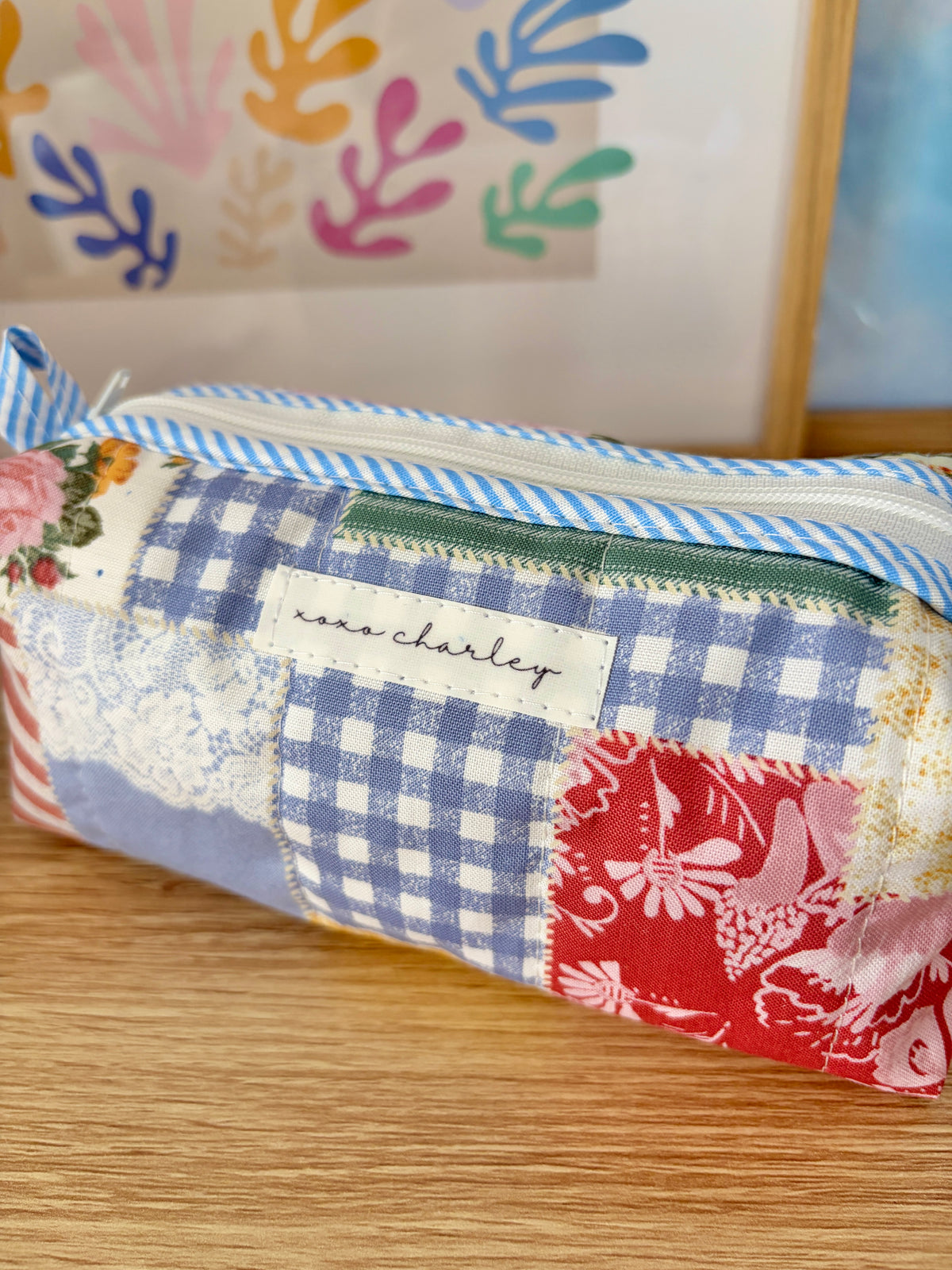 Colorblock picnic bag front panel with blue gingham squares and red floral fabric