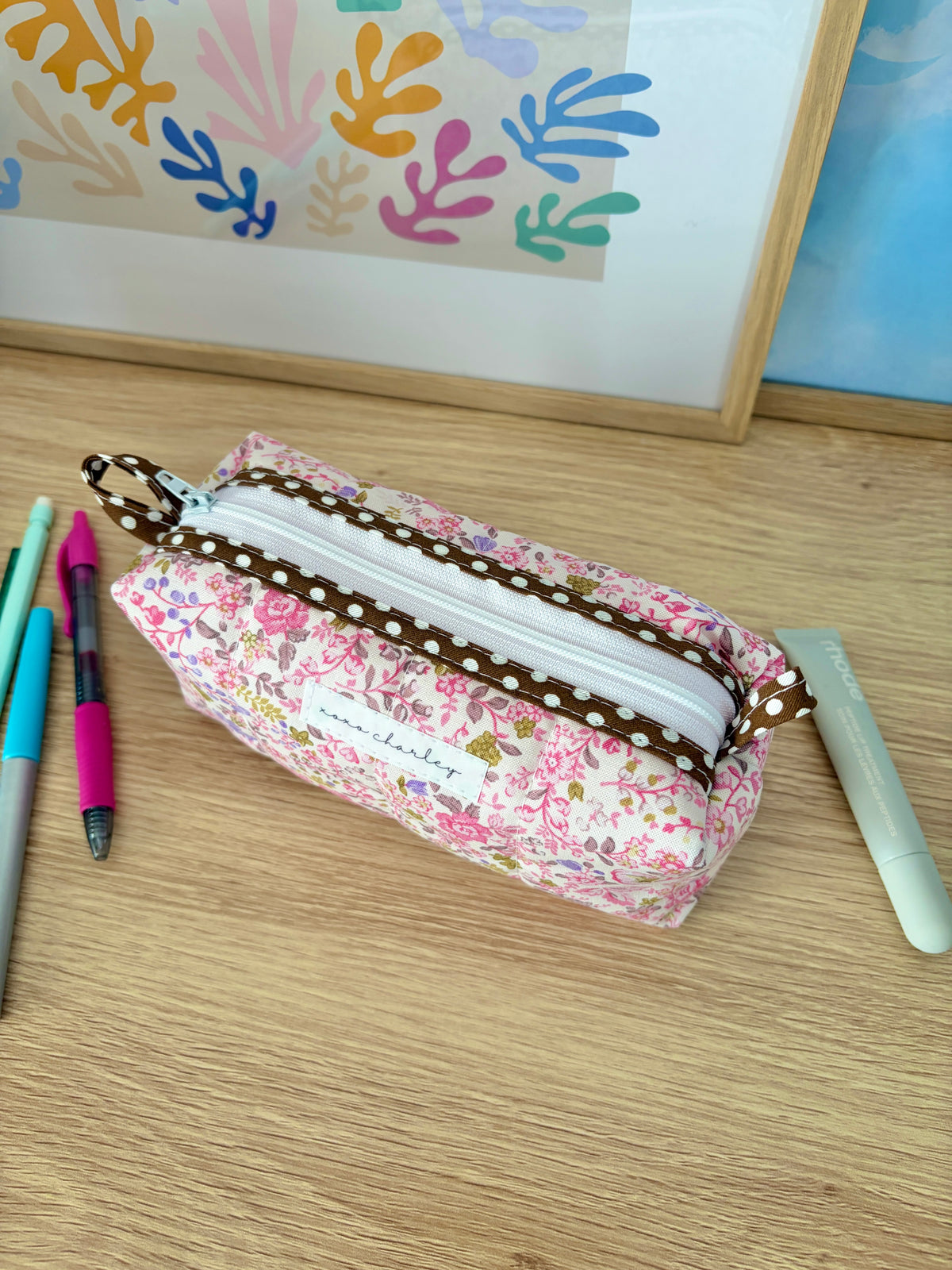 Pink floral zip pouch bag with white zipper and brown polka dot trim